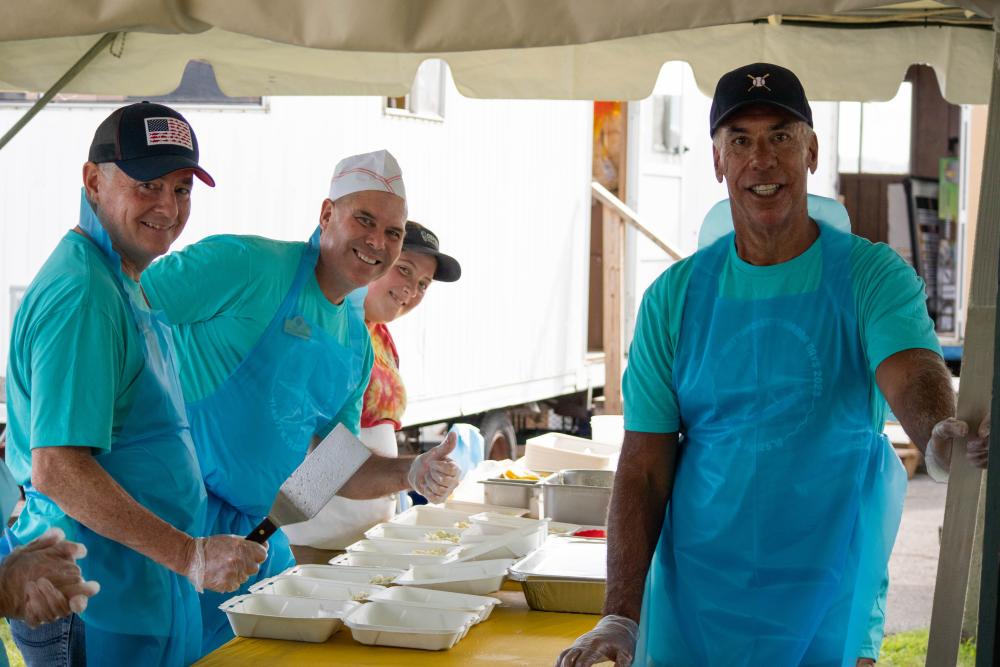 Mattapoisett Lions Club members serve up fish and chips from Oxford Creamery at the annual Friday Fish Fry in July. Photo by Sawyer Smook-Pollitt